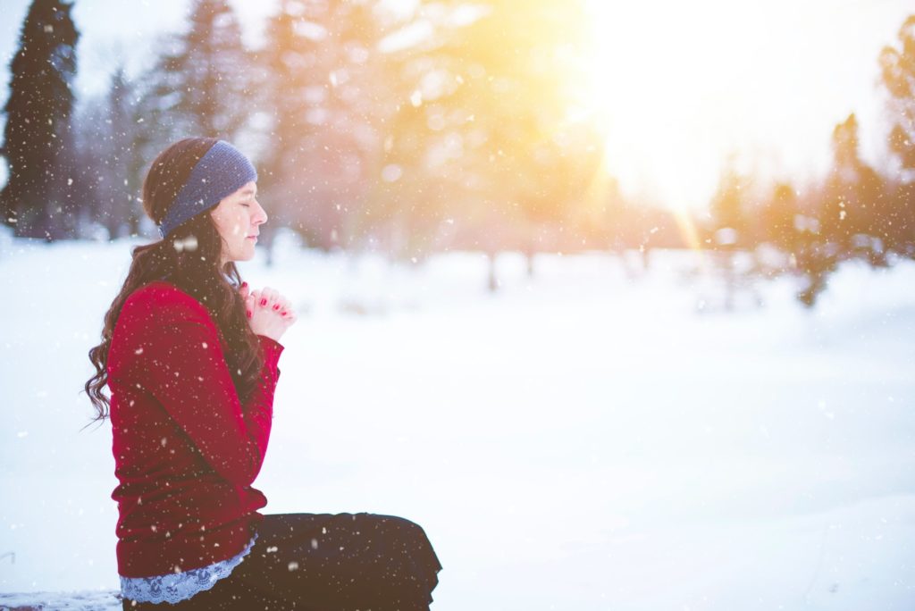 woman praying in winter